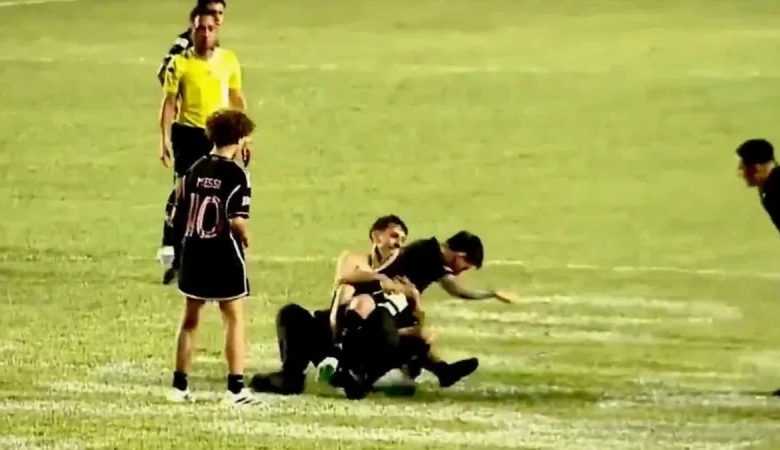 A fan knocks Messi to the ground during Inter Miami's friendly match in Puerto Rico